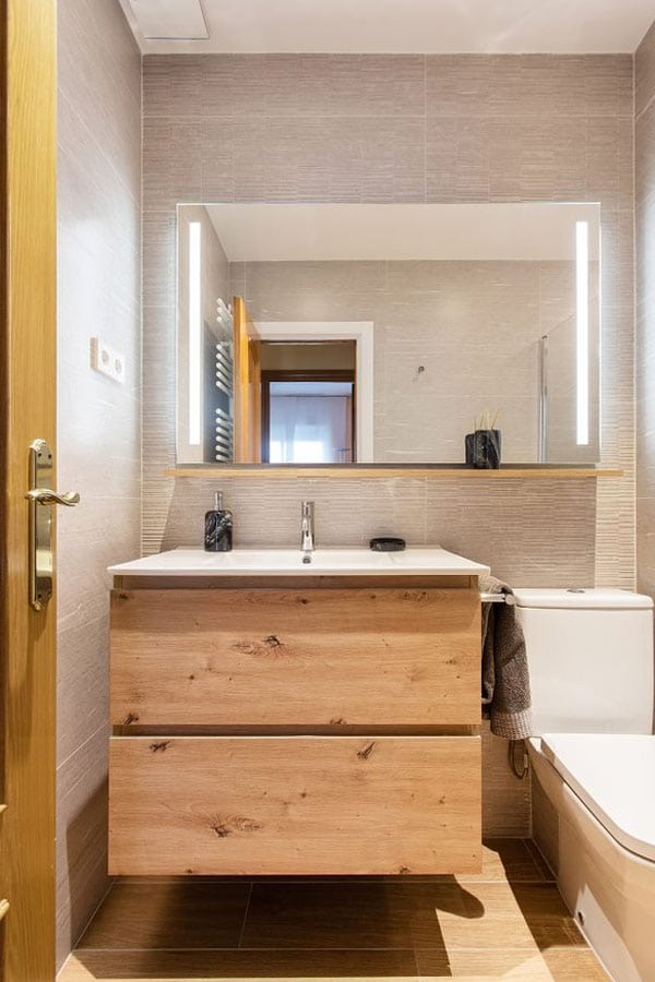 Baño moderno con espacio de almacenamiento en acabado madera